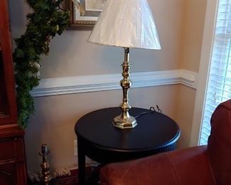 Heavy brass lamps contemporary table. Leather sofa.