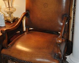 Fabulous oversized brown stamped leather carved mahogany chair with nail head trim design, 29"w x 44"h x 25"d