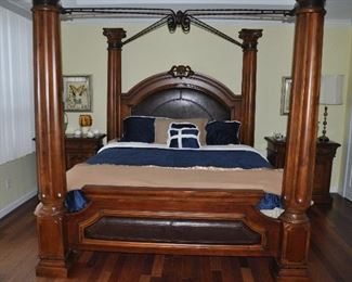 King size four column poster bed with black scroll canopy top and leather inserts on the headboard and foot board