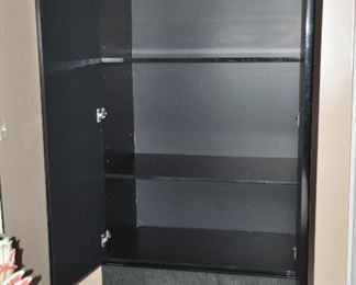 Armoire interior has 3 shelves and a clothes hanging bar
