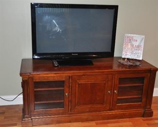 Ethan Allen cherry media center with two glass door and one cabinet.  63.5"w x 25"h x22"d.  Shown with a 42" Panasonic Plasma HDTV