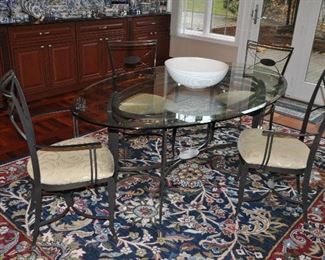 Lovely oval beveled glass and bronze metal dining table and chair set from Scott Shuptrine, table is 72" w x 42"d x 28.5"h.  Shown with a navy, red and cream floral area rug, machine made 10'3" x 7'8"