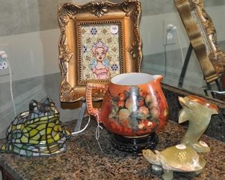 Adorable stained glass Tiffany style frog lamp shown with an antique signed M. Wakeman Cider Pitcher, onyx/marble figurines and a small framed art picture, Pixie by McLenon