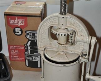 Badger 5 1/2 HP NIB garbage disposal shown with vintage Enterprise Manufacturing Company cast iron sausage maker