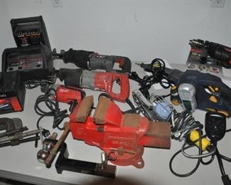 Selection of bench and power tools including clamps, lights, reciprocating saws, drills and more