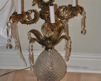 A large ornate brass and cut glass table lamps with partial crystal drops