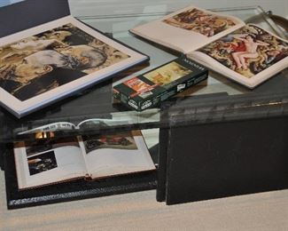 Contemporary glass and black painted texture two tier coffee table.  48"w x 30"d.  Shown with a collection of art books.