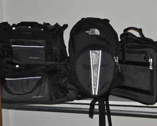 Eddie Bauer duffel bags, North Face backpack and Samsonite black ballistic computer bag