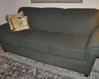 Three cushion hunter green upholstered sofa by Norwalk Furniture, 84”w x 34”h x 34”d 