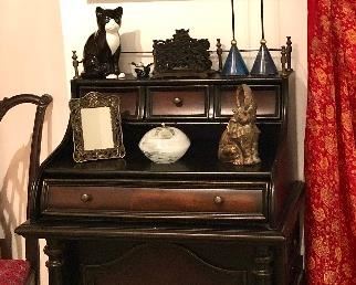 Wonderful, petite Hooker desk with big features. Fold down front to accommodate your keyboard. One nice deep drawer for supplies plus a filing drawer on the right side. A door on the left with hidden shelves and a file pocket. Three mini drawers atop the upper platform for organizing with an attractive and functional gallery rail. Hooker makes furniture that will last a lifetime. Heavy, solid wood!