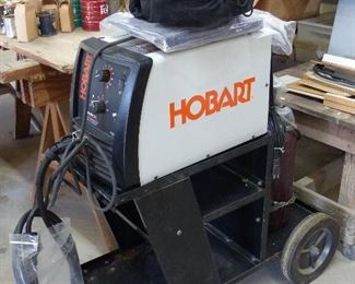 Hobart Mig Welder, cart, helmet, regulator, wire welding pliers, organ gas, & regulator