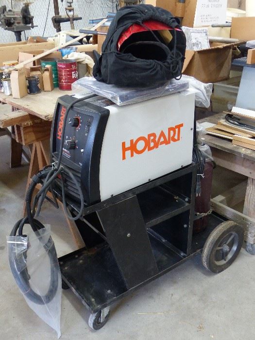 Hobart Mig Welder, cart, helmet, regulator, wire welding pliers, organ gas, & regulator