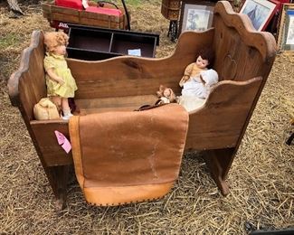 Dolls and antique cradle