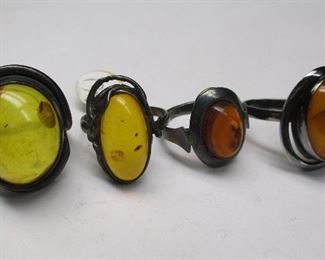 FOUR POLISH STERLING AND AMBER RINGS. Sizes 9 3/4, 9 1/2, 7 1/2, 7 1/4.

