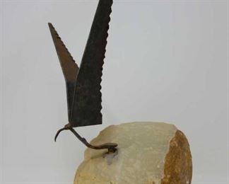 metal bird sculpture on a stone base