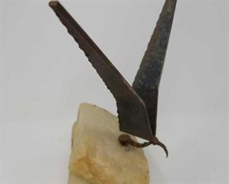 metal bird sculpture on a stone base