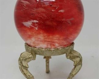 red crystal ball on stand