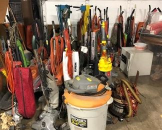 large lot of commercial vacuums