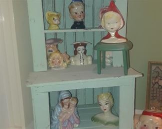 Primitive miniature stepback cupboard with several Head vases