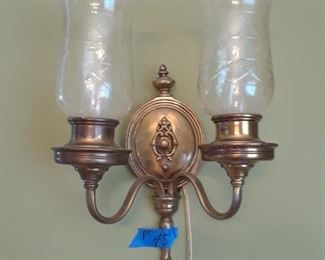 One of a pair of oval brass wall sconces with etched glass shades
