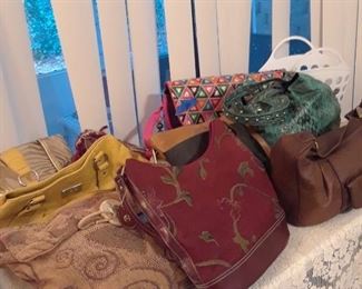 Lots of handbags, many makers and styles