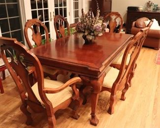 Rustic Dining Table and 8 Solid Chairs. It has A Nice Informal Look