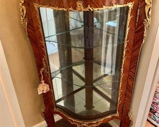 Marble topped ormolu corner display cabinet with glass shelves and front.