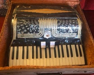 This is an antique accordion. It is way wore awesome than anything in your house right now,