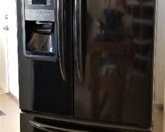Refrigerator freezer with ice and water dispenser on door. 