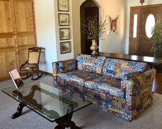 Ethan Allen multicolored sofa, glass top coffee table, cane Victorian rocker