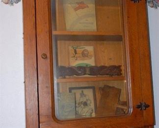Awesome hanging bookshelf in quartersawn oak. Beveled glass follows the round contour of the oak frame.
