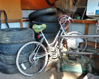 Lawn mowers, bicycles, tires, in one of the sheds 