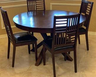 Contemporary Dark Wood Dining Table w/ 4 Chairs	Table: 30.5in H x 51 in Diameter.   Chairs: 39x18x19in seat height : 19.5in H	HxWxD
