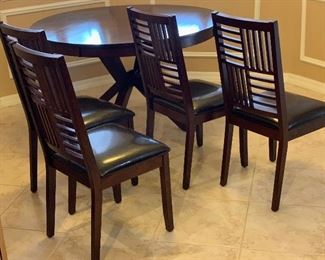 Contemporary Dark Wood Dining Table w/ 4 Chairs	Table: 30.5in H x 51 in Diameter.   Chairs: 39x18x19in seat height : 19.5in H	HxWxD
