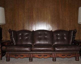Vintage 1970’s Solid Wood Colonial Sofa with Brown Naugahyde Upholstery Shown with Matching End Tables and Copper and Stain Glass Table Lamps