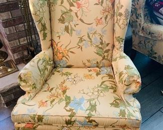 one of two upholstered wing back chairs