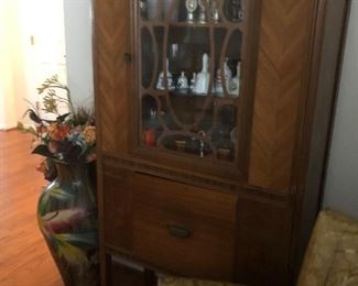 Elegant china cabinet with decorative glass woodwork. 