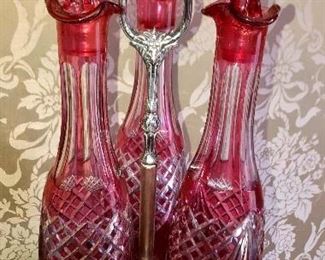 Triple red cut glass decanter set in filigree silver caddy