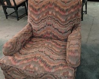 One of a pair flame pattern club chair.