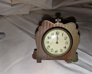 Very unique small clock . Brass