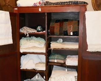 Great old cabinet full of vintage linens and coverlets