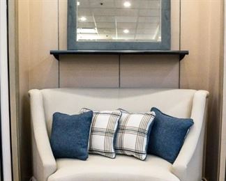 What a unique, rounded loveseat! The mirror above pulls in those colors of the pillows (actually they are the same color). We have two sitting chairs that look nice with this too.