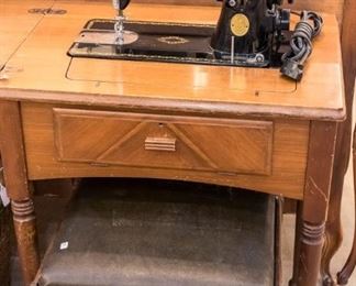 Vintage Singer in cabinet.