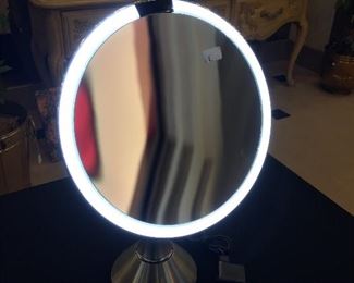Simplehuman Sensor Lighted Makup Vanity Mirror. The mirror is 8" round with touch control brightness,, 5x's magnification, brushed stainless and is reachable with cable. It's like new.