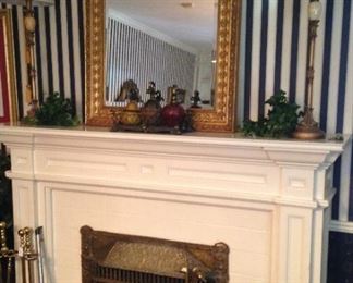 One of many framed mirrors; mantel lamps