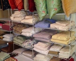 Many linens and decorative pillows