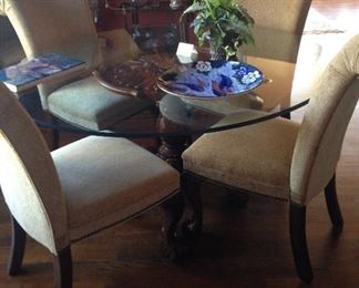 Four of six parson chairs; glass top table