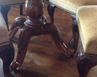 Intricately carved base; ball & claw front feet on the parson chairs