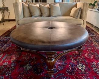 Maitland-Smith, leather coffee table/ottoman. Measures 52" in diameter and is 21" tall.