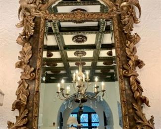 Large ornate gilded beveled mirror with pheasant detail. It measures 58"h x 34"w.